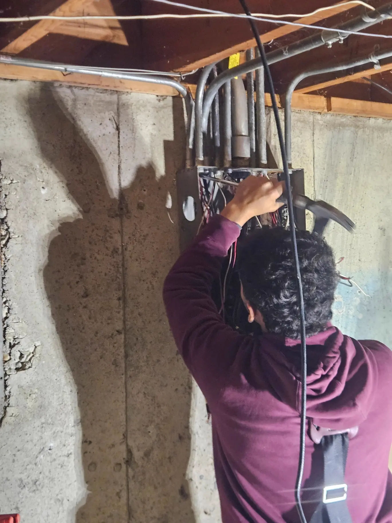 Electrician working on a basement panel